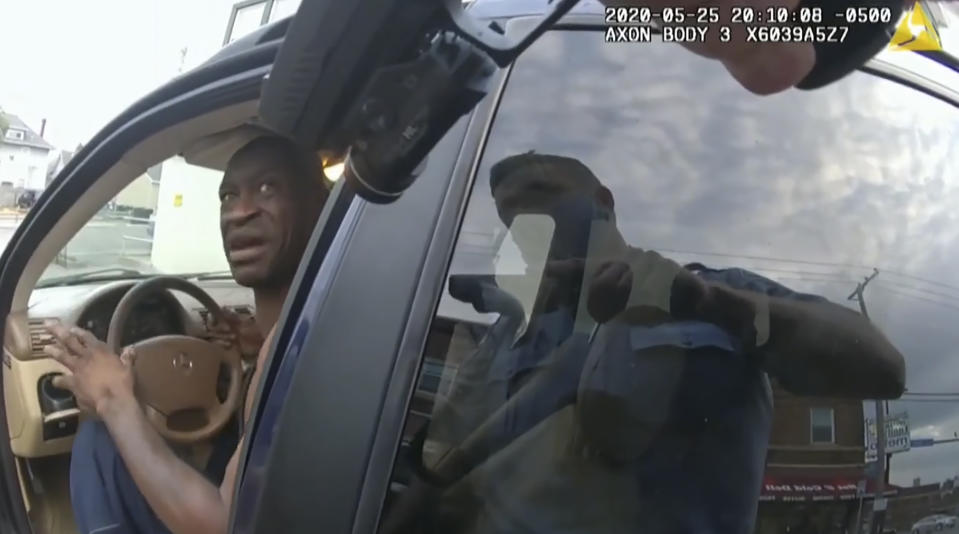 In this image from police body cam video, a Minneapolis police officer approaches George Floyd with a gun drawn, on May 25, 2020, outside Cup Foods in Minneapolis, as it is shown Wednesday, March 31, 2021, in the trial of former Minneapolis police Officer Derek Chauvin, in Floyd's death, at the Hennepin County Courthouse in Minneapolis. (Court TV via AP, Pool)