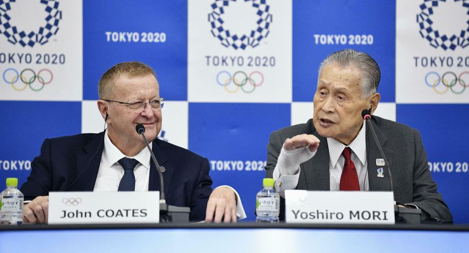 John Coates, left, chairman of the IOC Coordination Commission for the 2020 Tokyo Olympics and Paralympics, Tokyo Olympic organizing committee President Yoshiro Mori, right, attend a press conference Thursday, May 23, 2019, in Tokyo. A top Olympic official has made a guarantee that should please world sports federations that are concerned that organizers of next year’s Tokyo games might be cutting things that federations view as “essential.” (Tsuyoshi Ueda/Kyodo News via AP)