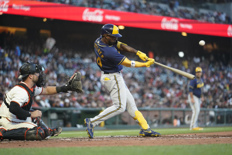 Milwaukee Brewers' Andrew McCutchen hits an RBI sacrifice fly against the San Francisco Giants during the fourth inning of a baseball game in San Francisco, Thursday, July 14, 2022. (AP Photo/Godofredo A. Vásquez)