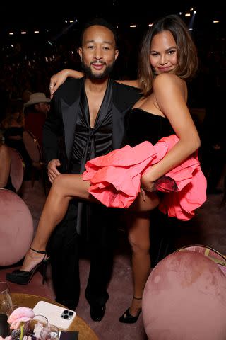 <p>Kevin Mazur/Getty </p> (L-R) John Legend and Chrissy Teigen attend the 66th GRAMMY Awards at Crypto.com Arena