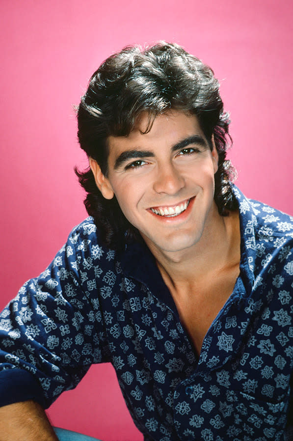 Even in this 1985 headshot (and sporting quite the mullet) we love George's winning smile.