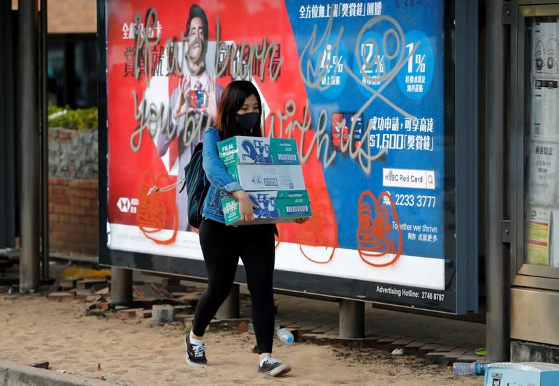 A woman carries supplies for the protestors outside the Polytechnic University in Hong Kong