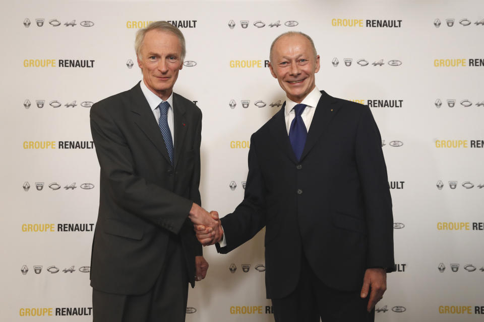 New Renault chairman Jean-Dominique Senard, left, shakes hands with Renault CEO Thierry Bollore after being appointed following a meeting of the board held at Renault headquarters in Boulogne-Billancourt, outside Paris, France, Thursday, Jan. 24, 2019. The board of French carmaker Renault has chosen new leadership to replace industry veteran Carlos Ghosn, naming Jean-Dominique Senard as chairman and Renault executive Thierry Bollore as CEO. (AP Photo/Christophe Ena)