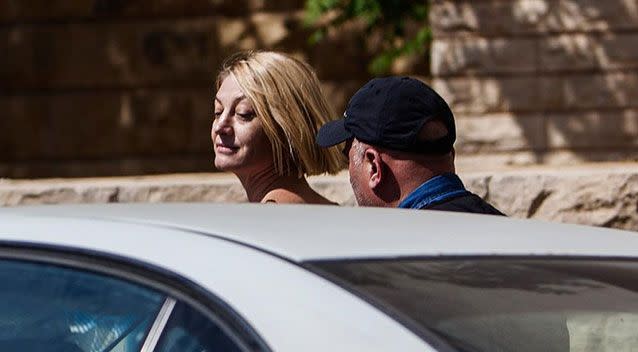 Tara Brown was dressed head to toe in black when she was photographed being led from the Palace of Justice. Photo: Getty