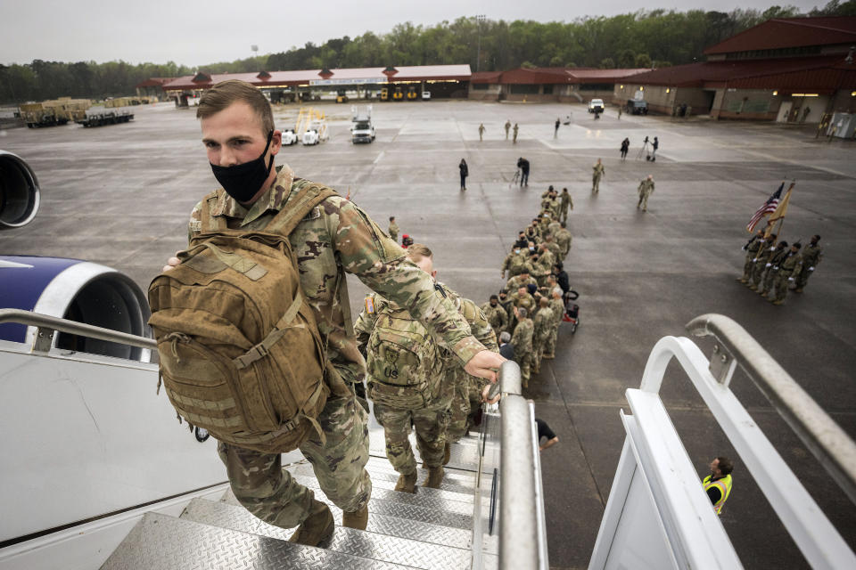 Soldiers with the U.S. Army's 87th Division Sustainment Support Battalion, 3rd Division Sustainment Brigade, board a chartered plane during their deployment to Europe, Friday, March 11, 2022, at Hunter Army Airfield in Savannah, Ga. The unit is attached to the Army's 3rd Infantry Division out of Fort Stewart, Ga., and will join the 3,800 troops from that division who already deployed in support of NATO in Eastern Europe. (AP Photo/Stephen B. Morton)