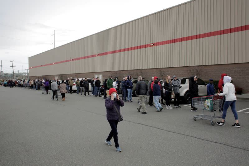 Shoppers line up before opening at a Costco store, following reports of coronavirus disease (COVID-19) cases in the country, in Seattle