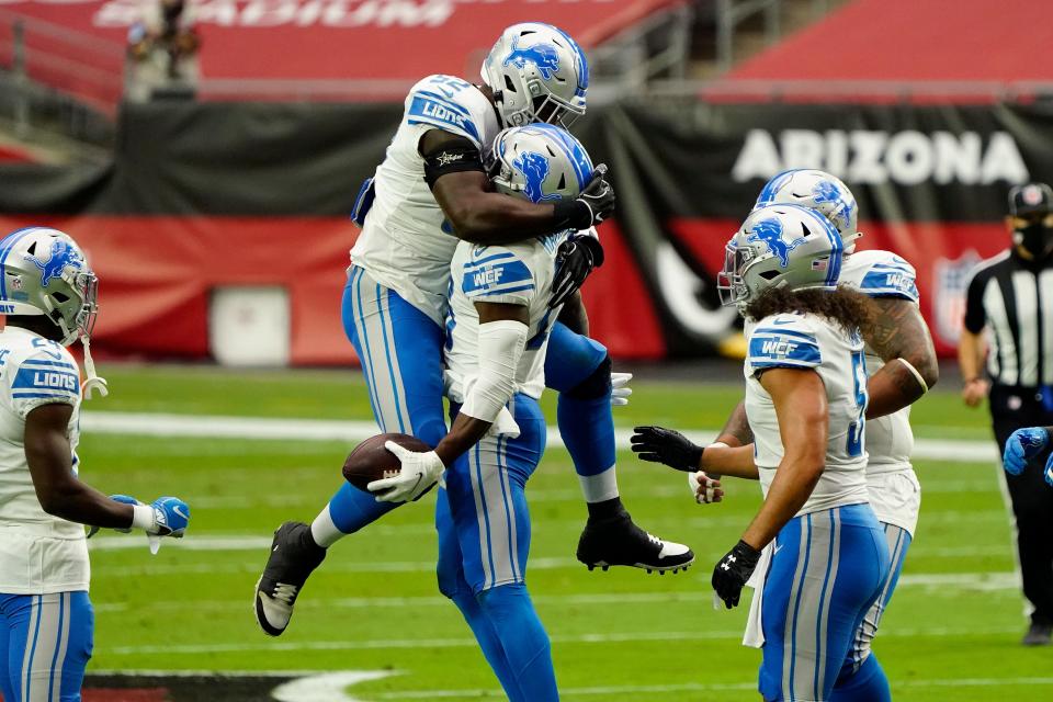 Lions safety Duron Harmon celebrates his interception against the Cardinals with linebacker Christian Jones, left, during the first half on Sunday, Sept. 27, 2020, in Glendale, Ariz.