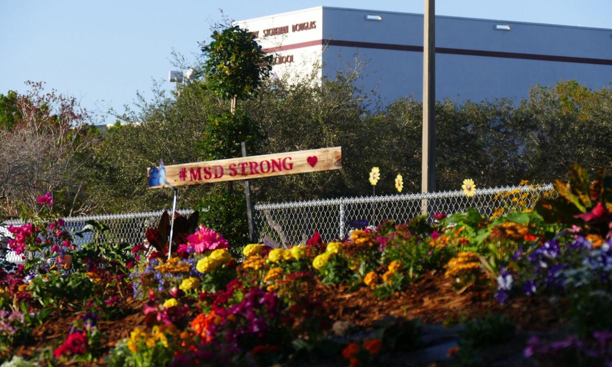 <span>A memorial of flowers and colorful stones in front of Marjory Stoneman Douglas high school on the first anniversary of the shooting.</span><span>Photograph: Miami Herald/TNS/Getty Images</span>