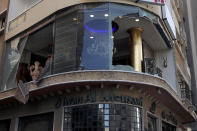 A storefront is seen with the windows broken during deadly clashes that erupted Thursday along a former 1975-90 civil war front-line between Muslim Shiite and Christian areas, in Ain el-Remaneh neighborhood, Beirut, Lebanon, Friday, Oct. 15, 2021. Schools, banks and government offices across Lebanon shut down Friday after hours of gun battles between heavily armed militias killed six people and terrorized the residents of Beirut. (AP Photo/Bilal Hussein)