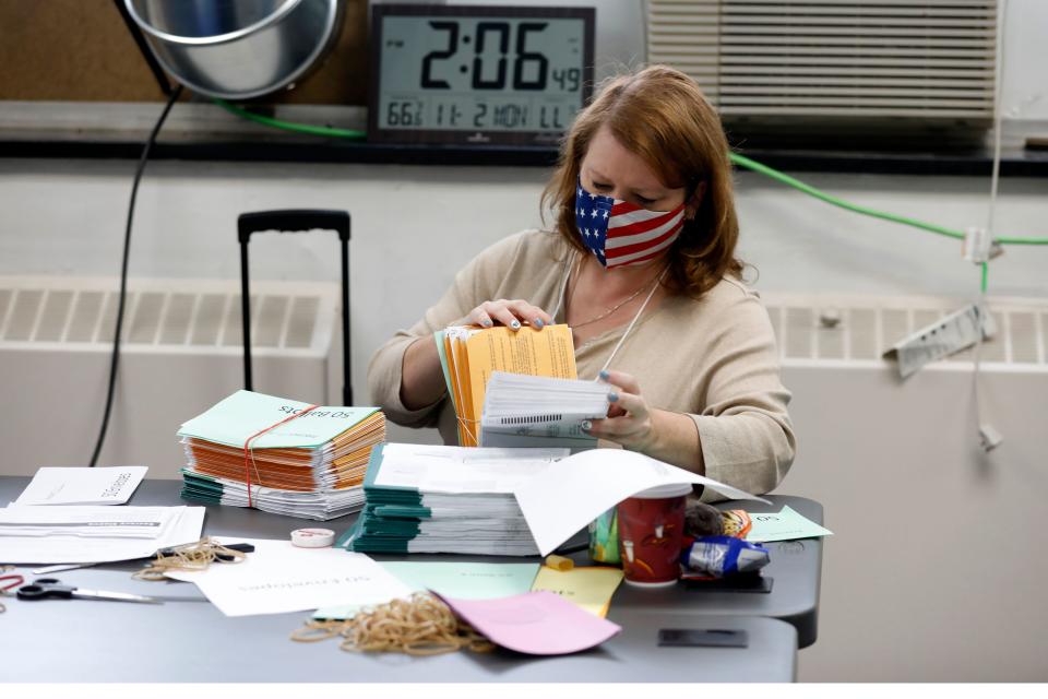 Workers start pre-processing absentee ballots at the city of Lansing Clerk's Election Unit on November 2, 2020 in Lansing, Michigan. - In Michigan workers can not scan absentee ballots until 7am ET on election day. (Photo by JEFF KOWALSKY / AFP) (Photo by JEFF KOWALSKY/AFP via Getty Images)