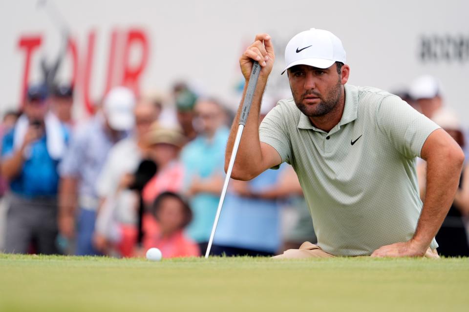 Scottie Scheffler lines up his putt on the fifth green during the final round of the TOUR Championship golf tournament. Mandatory Credit: John David Mercer-USA TODAY Sports