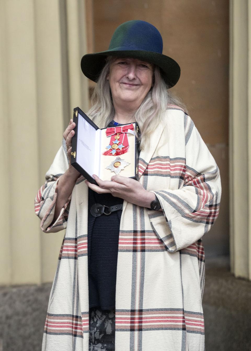 Mary Beard poses with her medal and insignia after she was appointed a Dame Commander of the Order of the British Empire (DBE) at an investiture ceremony at Buckingham Palace in London on December 7, 2018. (Photo by STEVE PARSONS / POOL / AFP via Getty Images)