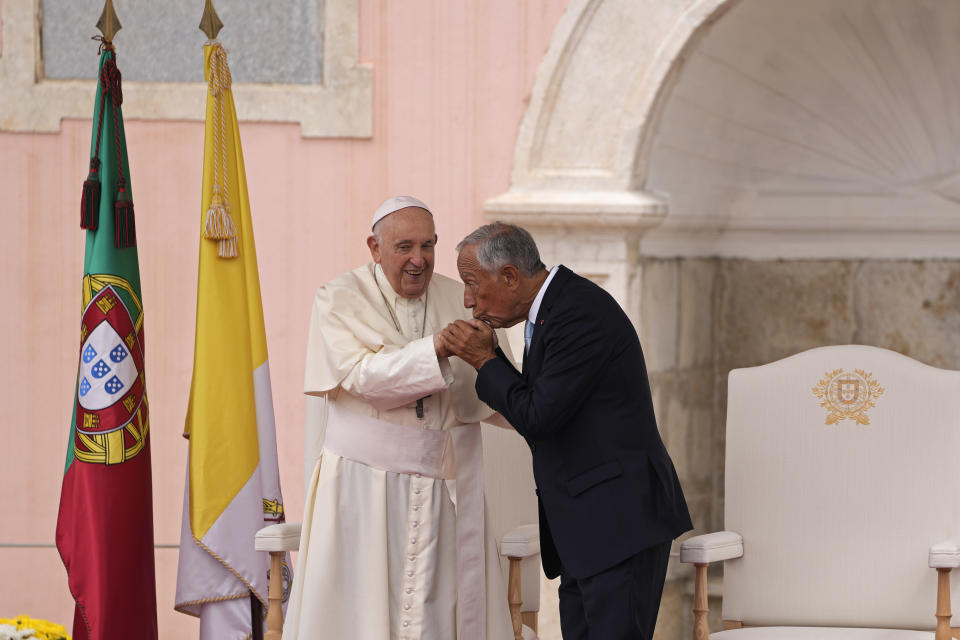 Portugal's President Marcelo Rebelo de Sousa, right kisses the hand of Pope Francis during the Welcome Ceremony at the Belem presidential palace in Lisbon, Wednesday, Aug. 2, 2023. Pope Francis starts his five-day pastoral visit to Portugal Wednesday that includes his participation at the 37th World Youth Day, and a pilgrimage to the holy shrine of Fatima. (AP Photo/Armando Franca)