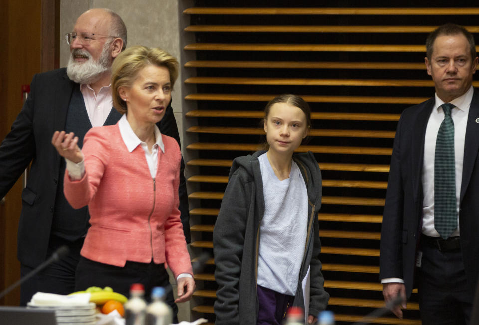 Swedish climate activist Greta Thunberg, center, and European Commission President Ursula von der Leyen, second left, arrive for the weekly College of Commissioners meeting at EU headquarters in Brussels, Wednesday, March 4, 2020. European Commission President Ursula von der Leyen, who has put climate change at the top of her priorities and pledged to make Europe the first climate neutral continent by 2050, will present her plans on Wednesday. (AP Photo/Virginia Mayo)