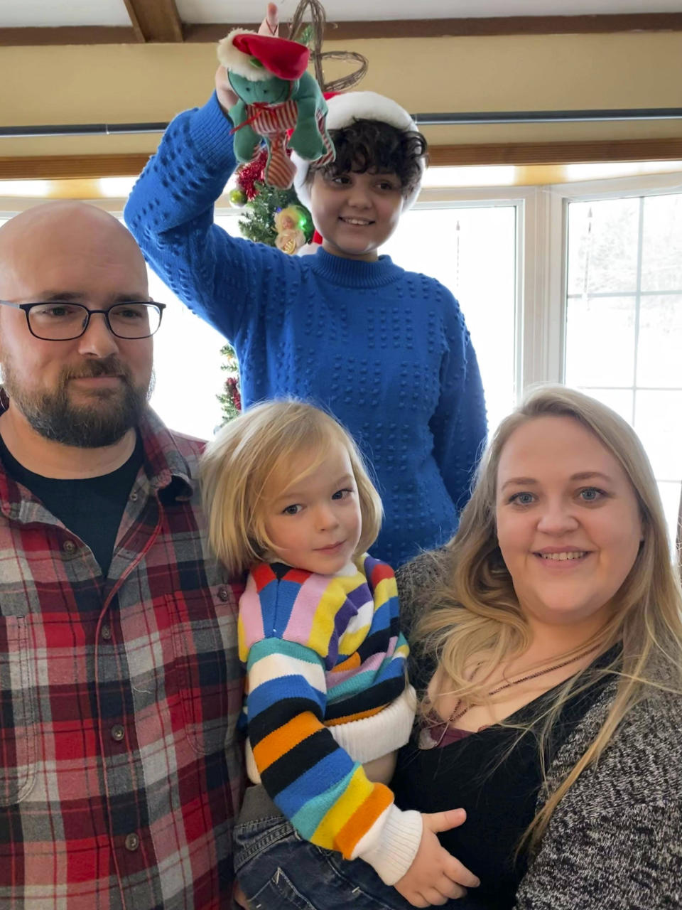 In this image provided by Kari Rodd, Kari Rod and her family pose in Cambridge, Minn., on Dec. 26, 2021. Rod said she and her family will qualify for Minnesota's new "North Star Promise" program that makes tuition free in 2024 at public colleges and universities for thousands of its residents with family income below $80,000. (Kari Rod via AP)