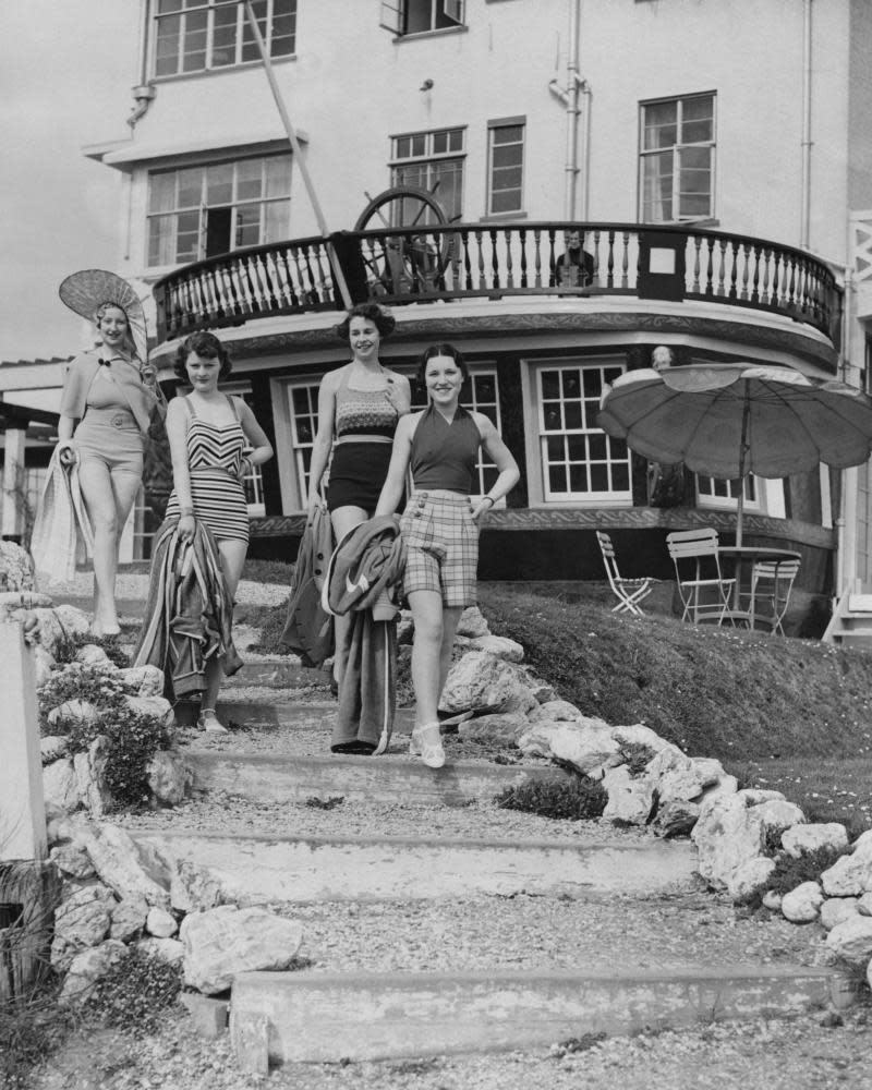 Holidaymakers leave the famous Burgh Island Hotel on Burgh Island, South Devon, 19th April 1935. The island was once used by smugglers and the hotel boasts a nautical theme, with a verandah built from the cabin of a warship. (Photo by Reg Speller/Fox Photos/Hulton Archive/Getty Images)