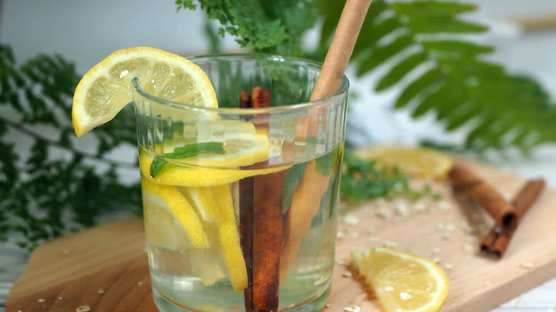 Glass with lemon, honey, and cinnamon sticks