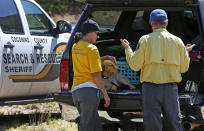 <p>Members of the Coconino County Search and Rescue Team take a break near the entrance to the First Crossing recreation area during the search and rescue operation for a victim in a flash flood along the banks of the East Verde River Monday, July 17, 2017, in Payson, Ariz. The bodies of several children and adults have been found after Saturday’s flash flooding poured over a popular swimming area in the Tonto National Forest. (AP Photo/Ross D. Franklin) </p>