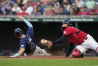 Tampa Bay Rays' Brandon Lowe (8) scores under the tag attempt of Cleveland Guardians catcher Bo Naylor during the first inning of a baseball game Friday, Sept. 1, 2023, in Cleveland. (AP Photo/Sue Ogrocki)