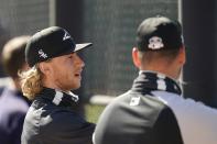 Chicago White Sox starting pitcher Michael Kopech, left, talks with a teammate during a spring training baseball practice Wednesday, Feb. 24, 2021, in Phoenix. (AP Photo/Ross D. Franklin)