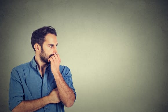 Worried man holding his hand to his mouth