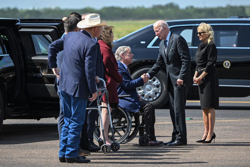 US President Joe Biden and First Lady Jill Biden greet Texas Governor Greg Abbott and others as they arrive at Garner Field Airport in Uvalde, Texas.