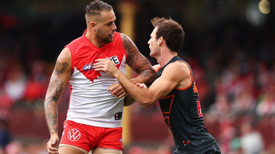 Lance Franklin jostles with a GWS Giants opponent.