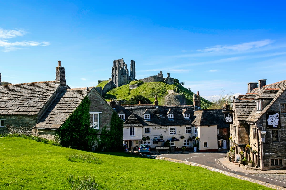 The ruins of Corfe Castle overlook the quintessentially English village of Corfe (Getty Images)