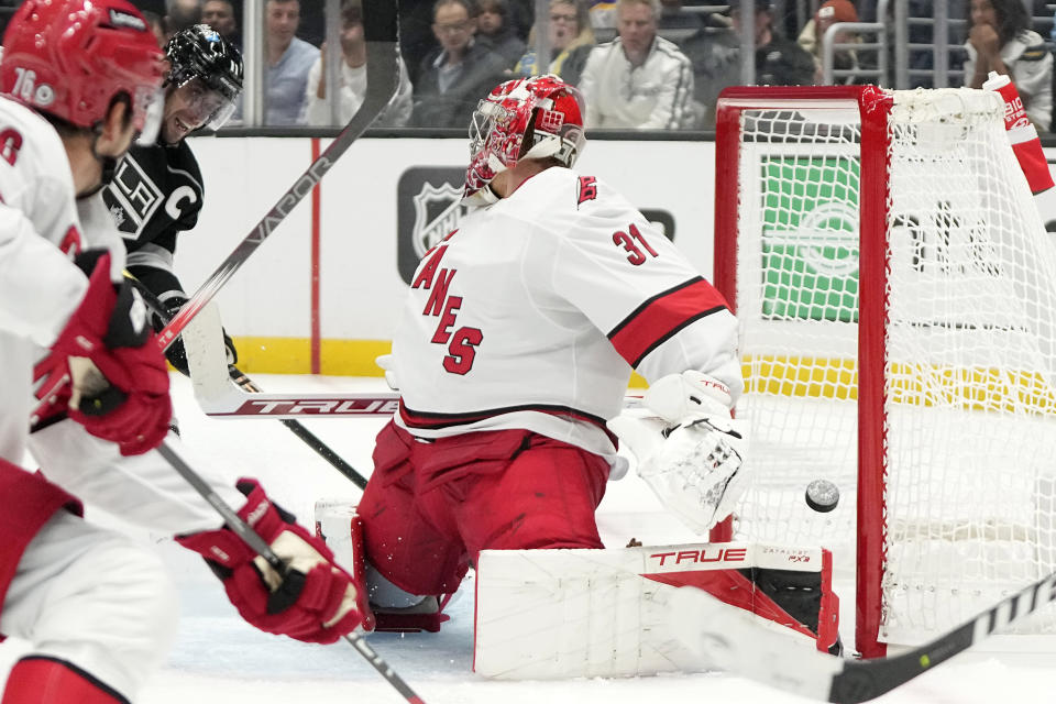 Los Angeles Kings center Anze Kopitar, second from left, scores on Carolina Hurricanes goaltender Frederik Andersen, right, during the second period of an NHL hockey game Saturday, Oct. 14, 2023, in Los Angeles. (AP Photo/Mark J. Terrill)