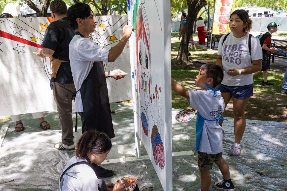 Families paint at the Mexican heritage center during Stockton Flavor Fest on Saturday, May 20, 2023, at Weber Point. The event had culinary vendors, food trucks, entertainment, performances, kids activities, craft beers and more.