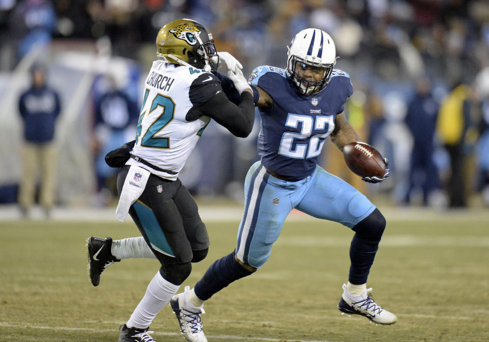Tennessee running back Derrick Henry tries to get past Jacksonville Jaguars safety Barry Church in the second half of a 15-10 victory that puts the Titans back in the playoffs for the first time in nearly a decade. (AP Photo)