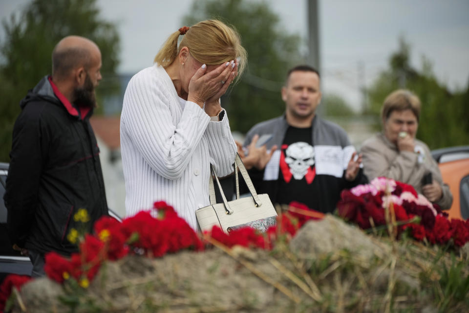 A woman reacts at an informal memorial next to the former 'PMC Wagner Centre' in St. Petersburg, Russia, Thursday, Aug. 24, 2023. Russian mercenary leader Yevgeny Prigozhin, the founder of the Wagner Group, reportedly died when a private jet he was said to be on crashed on Aug. 23, 2023, killing all 10 people on board. (AP Photo/Dmitri Lovetsky)