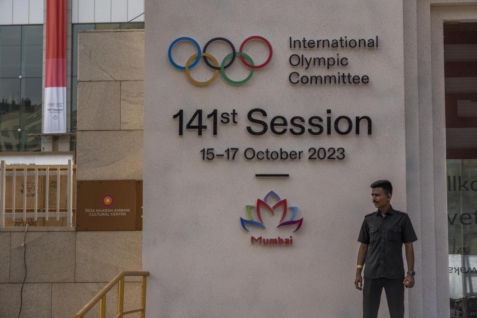 A security guard stands at the entrance of a venue ahead of the upcoming 141st International Olympic Committee (IOC) session in Mumbai, India, Thursday, Oct. 12, 2023.(AP Photo/Rafiq Maqbool)