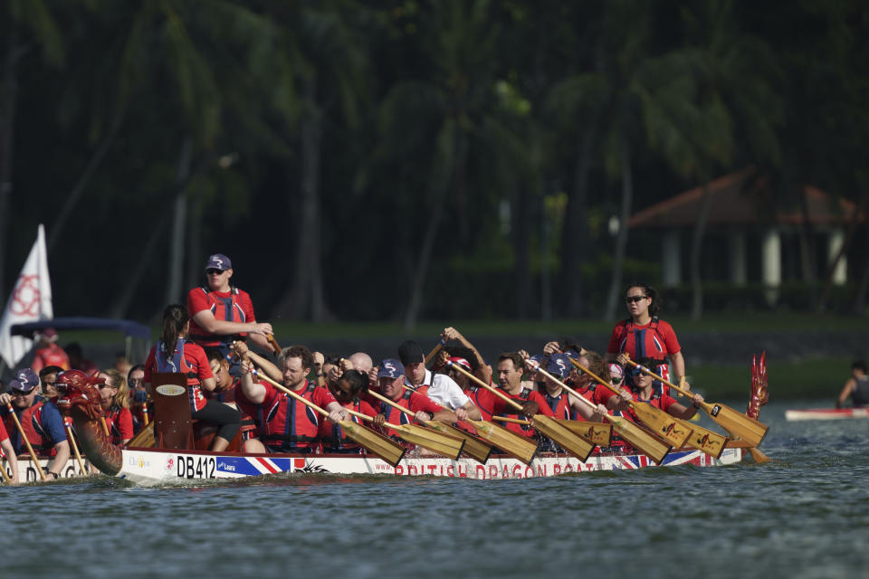 Britain's Prince William, center, participates in a dragon boat event in Singapore, Monday, Nov. 6, 2023. (AP Photo/Vincent Thian)
