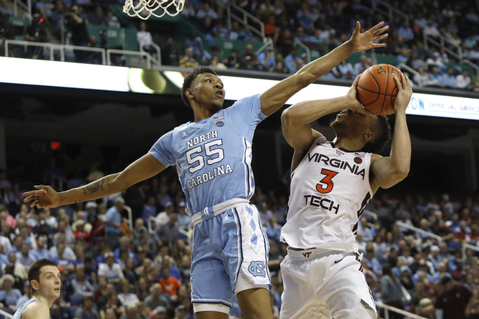 North Carolina guard Christian Keeling (55) blocks Virginia Tech guard Wabissa Bede (3) during the second half of an NCAA college basketball game at the Atlantic Coast Conference tournament in Greensboro, N.C., Tuesday, March 10, 2020. (AP Photo/Ben McKeown)