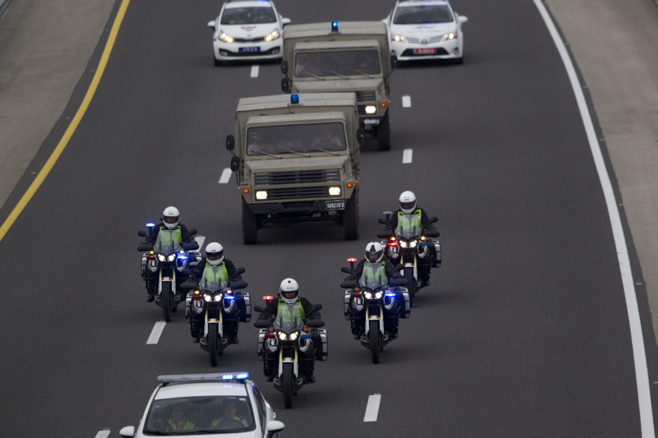 A military vehicle with the coffin of the late Israeli Prime Minister Ariel Sharon on route to Jerusalem from a military base near Rishon Letzion in central Israel, Sunday, Jan. 12, 2014. The body of Ariel Sharon, Israel's hard-charging former prime minister and general will be brought to Israel's parliament building in Jerusalem where it will lie in state Sunday a day after his death aged 85. (AP Photo/Ariel Schalit)