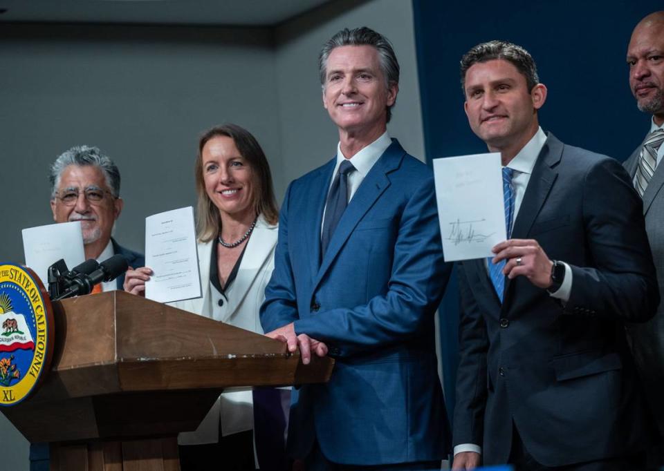 Gov. Gavin Newsom, center, stands with gun control bill authors, from far left, state Sen. Anthony Portantino, D-Burbank, state Sen. Catherine Blakespear, D-Encinitas, and Assemblyman Jesse Gabriel, D-Woodland Hills, after he signed their bills Tuesday, Sept. 26, 2023.