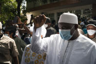 Gambian President Adama Barrow leaves the polling station after casting his vote in Gambia's presidential elections in Banjul, Gambia, Saturday, Dec. 4, 2021. Gambians vote in a historic election that will for the first time not have former dictator Yahya Jammeh, who ruled for 22 years, on the ballot. (AP Photo/Leo Correa)