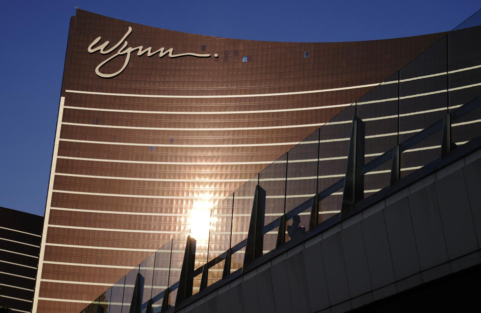 FILE - People walk along a pedestrian bridge near the Wynn Las Vegas hotel-casino Thursday, Sept. 17, 2020, in Las Vegas. After a marathon week of negotiations, the Las Vegas hotel workers union says it has reached a tentative deal with Wynn Resorts. It was the last contract the Culinary Workers Union needed to avoid a strike Friday, Nov. 10, 2023, and came after the union's tentative deals with Caesars Entertainment and MGM Resorts. (AP Photo/John Locher, File)