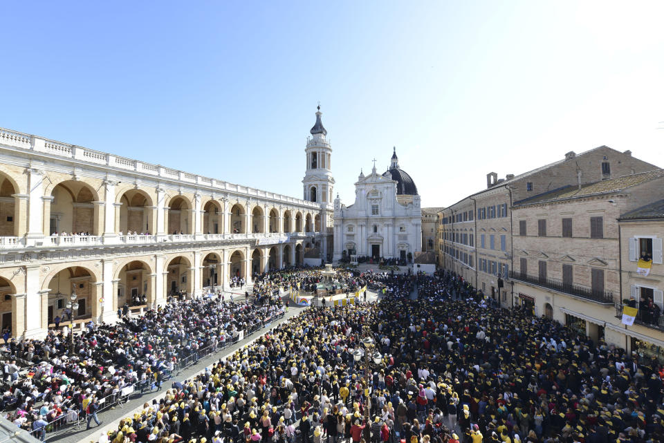 Faithful wait in Piazza della Madonna Square for Pope Francis to arrive at the Catholic Shrine of Our Lady of Loreto in central Italy for a one-day visit, Monday, March 25, 2019. The pope chose Loreto to sign the Post-Synodal Exhortation of last October's Synod of Bishops. (AP Photo/Sandro Perozzi)