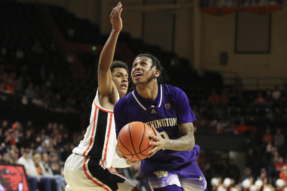 Washington guard Koren Johnson (0) drives to the basket past Oregon State guard Josiah Lake II (2) during the second half of an NCAA college basketball game Saturday, Feb. 10, 2024, in Corvallis, Ore. Washington won 67-55. (AP Photo/Amanda Loman)