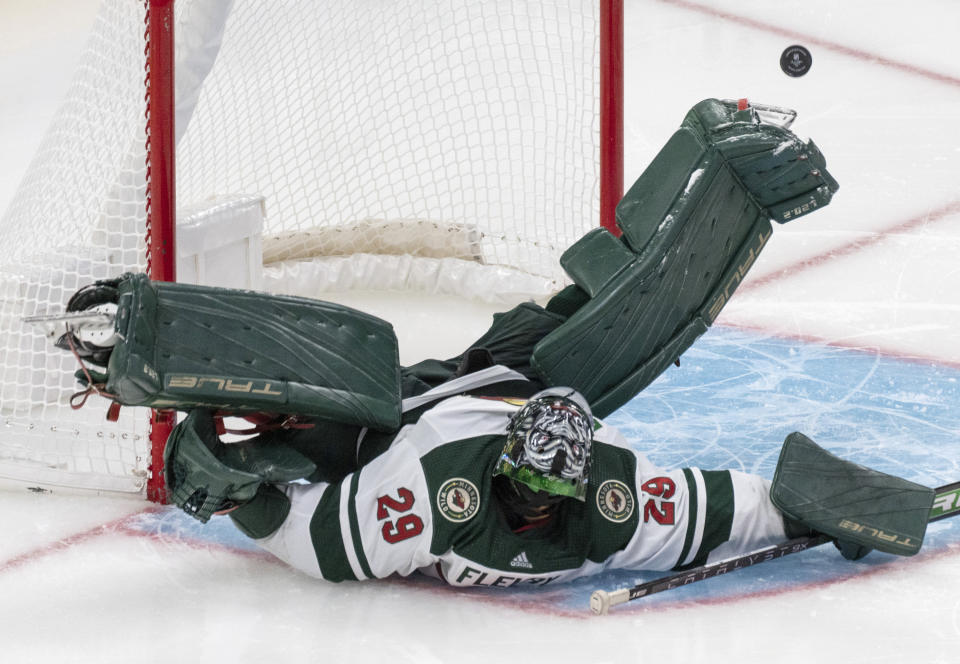 Minnesota Wild goaltender Marc-Andre Fleury makes a save during the third period of an NHL hockey game against the Montreal Canadiens, Tuesday, Oct. 17, 2023 in Montreal. (Christinne Muschi/The Canadian Press via AP)