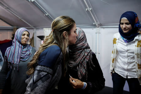 Queen Rania of Jordan (L) embraces a Syrian refugee woman during her visit at the Kara Tepe refugee camp on the island of Lesbos, Greece April 25, 2016. REUTERS/Alkis Konstantinidis