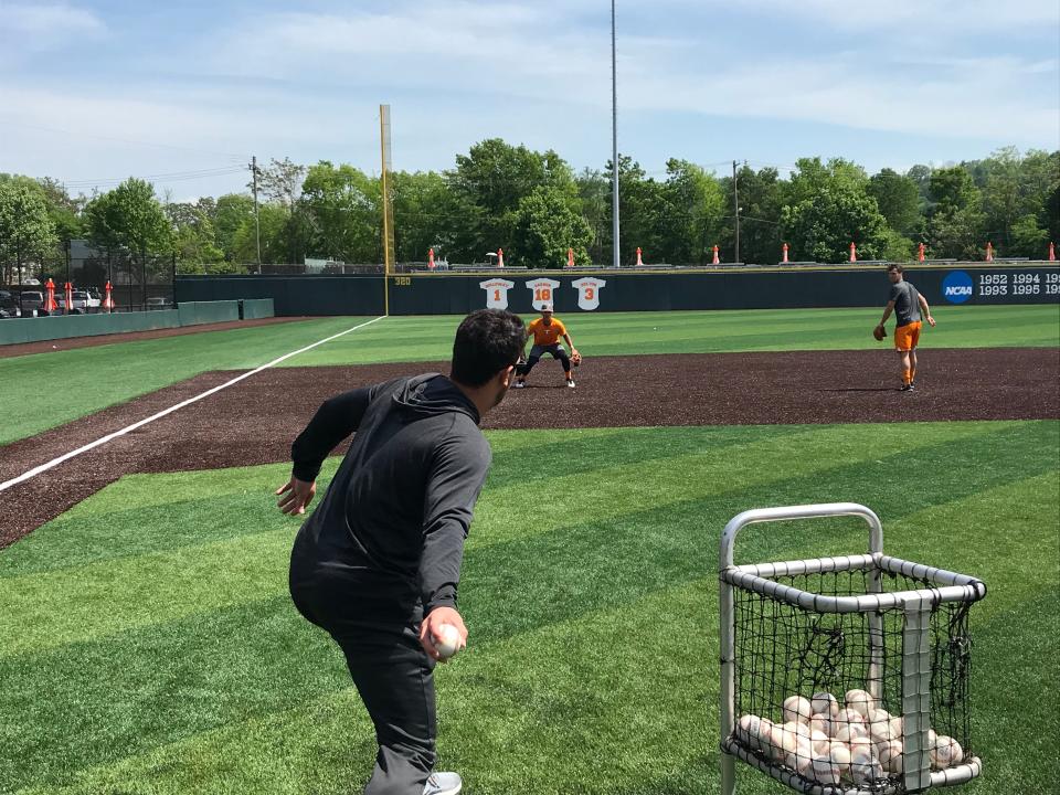 Tennessee volunteer assistant coach Ross Kivett throws ground balls to Trey Lipscomb and Andre Lipcius on April 29, 2019.