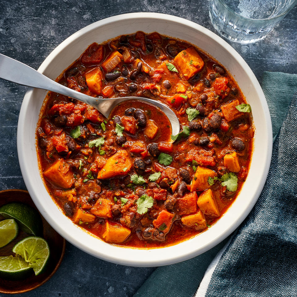 <p>Make a double batch of this quick vegetarian chili, full of black beans and sweet potatoes, and eat it for lunch the next day or freeze the extras for another night. We love the smoky heat from the ground chipotle, but omit it if you prefer a mild chili. Serve with tortilla chips or cornbread and coleslaw.</p> <p> <a href="https://www.eatingwell.com/recipe/250222/sweet-potato-black-bean-chili/" rel="nofollow noopener" target="_blank" data-ylk="slk:View Recipe;elm:context_link;itc:0" class="link ">View Recipe</a></p>