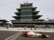 FILE - In this May 29, 2011, file photo, IndyCar driver Dan Wheldon, of England, crosses the finish line to win the Indianapolis 500 auto race at the Indianapolis Motor Speedway in Indianapolis. The Associated Press has updated its survey of living Indianapolis 500 winners and their pick as the greatest race in the long history of the event. There are six races that received multiple votes, topped by Al Unser Jr.’s victory over Scott Goodyear in 1992 — the closest Indy 500 in history. The others are Emerson Fittipaldi's win in 1989; Sam Hornish Junior's win in 2006; the 1982 battle between Rick Mears and Gordon Johncock; the 2011 race won by the late Wheldon; and the 2014 thriller won by Ryan Hunter-Reay.(AP Photo/Darron Cummings, File)