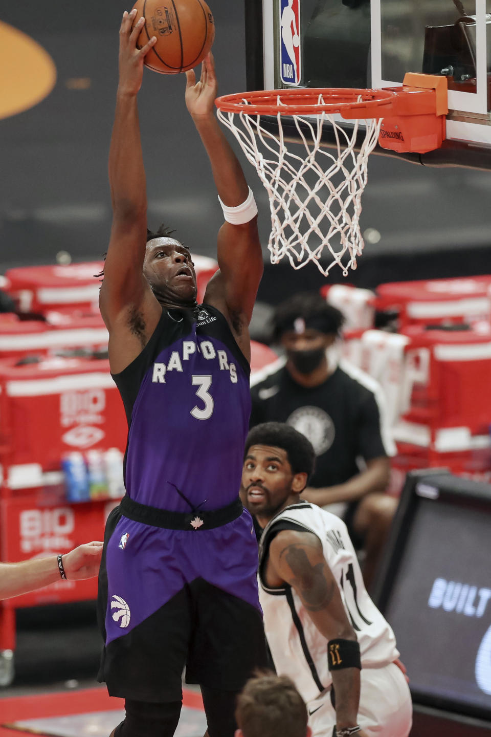 Toronto Raptors' OG Anunoby dunks past Brooklyn Nets' Kyrie Irving during the second half of an NBA basketball game Wednesday, April 21, 2021, in Tampa, Fla. (AP Photo/Mike Carlson)
