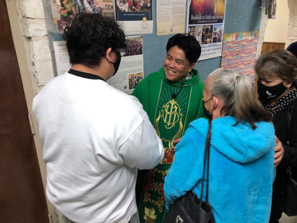 The Rev. Ryan Carnecer greets parishioners after a recent Sunday mass at Divine Providence Catholic Church in San Antonio. Carnecer has urged parishioners to get vaccinated against COVID-19. Latino Catholics lead most U.S. major religious groups in vaccination rates, according to recent studies.