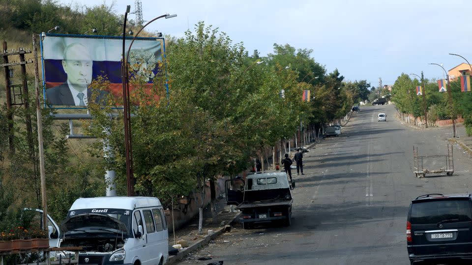 A billboard showing Russian President Vladimir Putin stands above a largely deserted road leading to Stepanakert after Azerbaijan's offensive, October 2, 2023. - Emmanuel Dunand/AFP/Getty Images