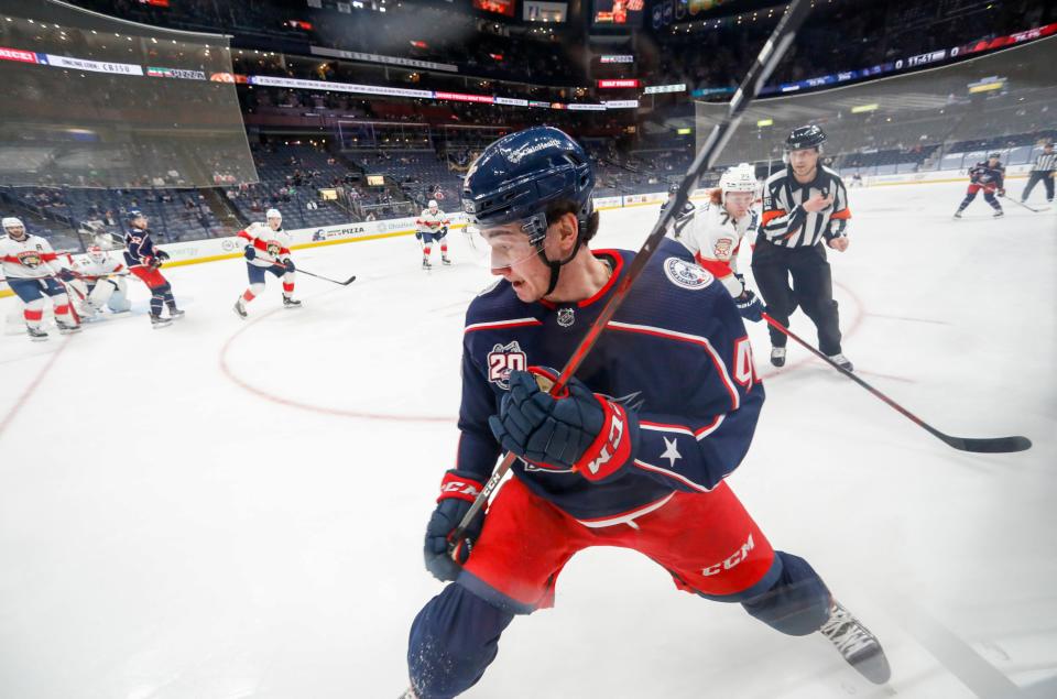 Columbus Blue Jackets center Alexandre Texier (42) looks for the puck in the corner ahead of Florida Panthers right wing Owen Tippett (74) during the first period of the NHL hockey game at Nationwide Arena in Columbus on Thursday, March 11, 2021. 